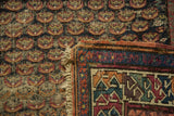 Antique Caucasian Soumac runner detail, displaying woven foundation, repeating motifs, and original fringe.