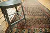 Repeating shrub design field and colorful geometric borders of an antique Caucasian Soumac runner.