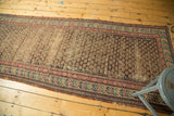 Antique Caucasian Soumac runner with repeating shrub field, rich geometric borders, and visible wear.