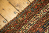 Antique Malayer runner displaying intricate boteh pattern, inner ivory border, and light tattered edge.