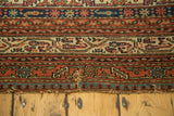 End of antique Persian Malayer runner, showing a split with exposed foundation and light tatter.