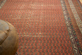 Antique Malayer runner detail: repeating boteh design across cinnabar red field with contrasting minor border.