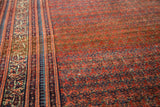 Intricate border and rainbow-like shrub boteh field of an antique Fine Malayer runner.