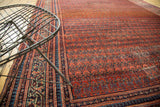 Detail of antique Malayer runner's brick red field with intricate shrub boteh, highlighting a patch.