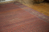 Antique Malayer runner showing intricate border and rainbow-like variegated red, blue field.