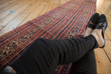 Antique Malayer runner's brick red and blue Laleh Abbasi and stylized vine patterns.