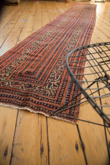 Antique Fine Malayer runner's fringed end, showing brick red, blue, and ivory Serbend vinery borders.