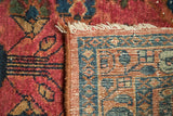 Lilihan runner corner with raspberry red pile, geometric blue and beige woven back, and cream fringe.