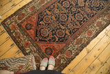 Antique Malayer rug, dense navy field with blush and tangerine vinery, light tatter visible.