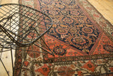 Antique Malayer rug's allover field with serrated leaves, vinery in navy, tangerine, and blush.