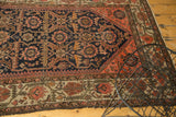 Antique Persian Malayer rug detail: serrated leaves, floral vinery, and borders in navy, blush, beige.