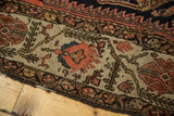 Intricate floral arabesques and serrated leaves in blush and tangerine on a silver ivory border.
