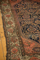 Antique Malayer rug: Blush floral border, navy field, vinery, and softly worn texture.