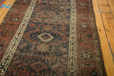 Antique Belouch runner showing geometric border, trellis field pattern, navy, copper, and original goats hair selvage.