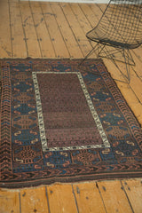 Antique Belouch rug's lower corner, with tattered ends, goat hair selvage, and geometric border guls.