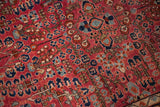 Burgundy red Sarouk pile featuring scattered floral bouquets and pinwheel designs.