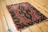 Dramatic rococo medallion of an Antique Lilihan rug, featuring fuchsia, chocolate, and teal.