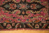 Antique Lilihan rug's lower border with curvilinear fuchsia and chocolate motifs, showing slight end loss.