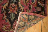 Antique Lilihan rug corner with fuchsia selvage, dark patterned pile, and woven reverse.