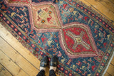 Vintage Caucasian Soumac rug: navy field with pictorial camels, birds, and human motifs.