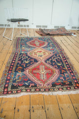 Red geometric medallion and diverse animal motifs on a navy Caucasian Soumac field.
