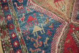 Close-up: hand woven Soumac rug with pictorial camel, bird, and people motifs.