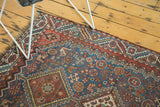 Evenly worn low pile showing geometric motifs and detailed borders on an antique Qashqai rug.