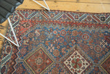 Low even pile and detailed geometric corner of an antique Persian Qashqai rug.