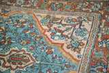 Persian Lilihan rug corner featuring intricate floral design in aqua, blush, and wine red.