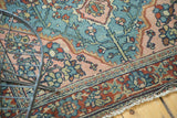 Tattered fringe and vintage Lilihan rug edge with aqua, blush, and wine red patterns.