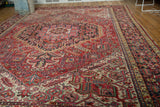 Detail of vintage Heriz carpet, with brick red, ivory geometric patterns and scrolling motifs.