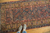 Antique Kurdish runner showcasing its allover Garden of Paradise motif with visible wear.