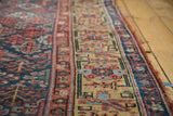 Antique Kurdish runner's saffron yellow border, intricate navy field, and storied edge tatter.