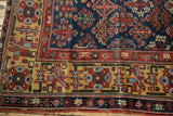 Antique Kurdish runner corner, saffron yellow geometric border and navy field patterns.