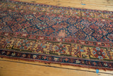 Antique Kurdish runner, navy Garden of Paradise field, visible foundation wear, frayed edge.