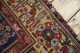 Hand-knotted pile texture, geometric patterns, and light edge wear on an antique Kurdish runner.