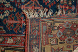 Antique Kurdish runner's hand-knotted foundation, tattered fringe, and navy geometric pattern.