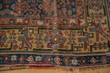Antique Kurdish rug runner border showing saffron yellow, madder red stylized motifs and tattered ends.