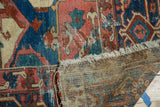 Worn pile exposing the hand-knotted foundation and secured selvage on an antique Serapi carpet.