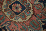 Rectilinear geometric tendrils and floral design in madder root red, navy blue, and antique ivory.