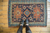 Antique Karaja rug corner detail with geometric field in navy, madder root red. Selvage separation visible.