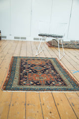 Antique Karaja rug's geometric field and serrated border with navy, madder red, sky blue.