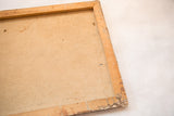Back of vintage painting canvas with aged beige texture and distressed wooden frame.
