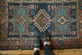 Antique Karaja rug detail: geometric denim blue, mallard green, and pale terra cotta design.