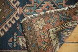 Detail of antique Karaja rug showing its hand-knotted foundation, distinct geometric pile, and tattered fringe.