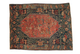 Antique Seichor Kuba rug: oversize oblong blush-red medallion with floral patterns, dark navy field.