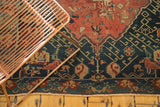 Antique Seichor Kuba rug: dark navy geometric border, red floral field, visible fringe.