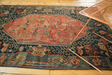 Antique Seichor Kuba lower section: dark navy geometric border, green vine motif, red floral field.