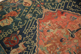 Unusual Armenian Seichor Kuba rug detail: indigo field with meandering hooks and red floral motifs.