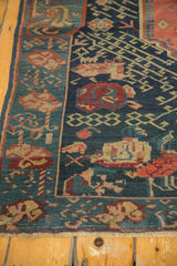 Antique Seichor Kuba rug, border with meandering hook and vine, navy, red, and oxidized green.